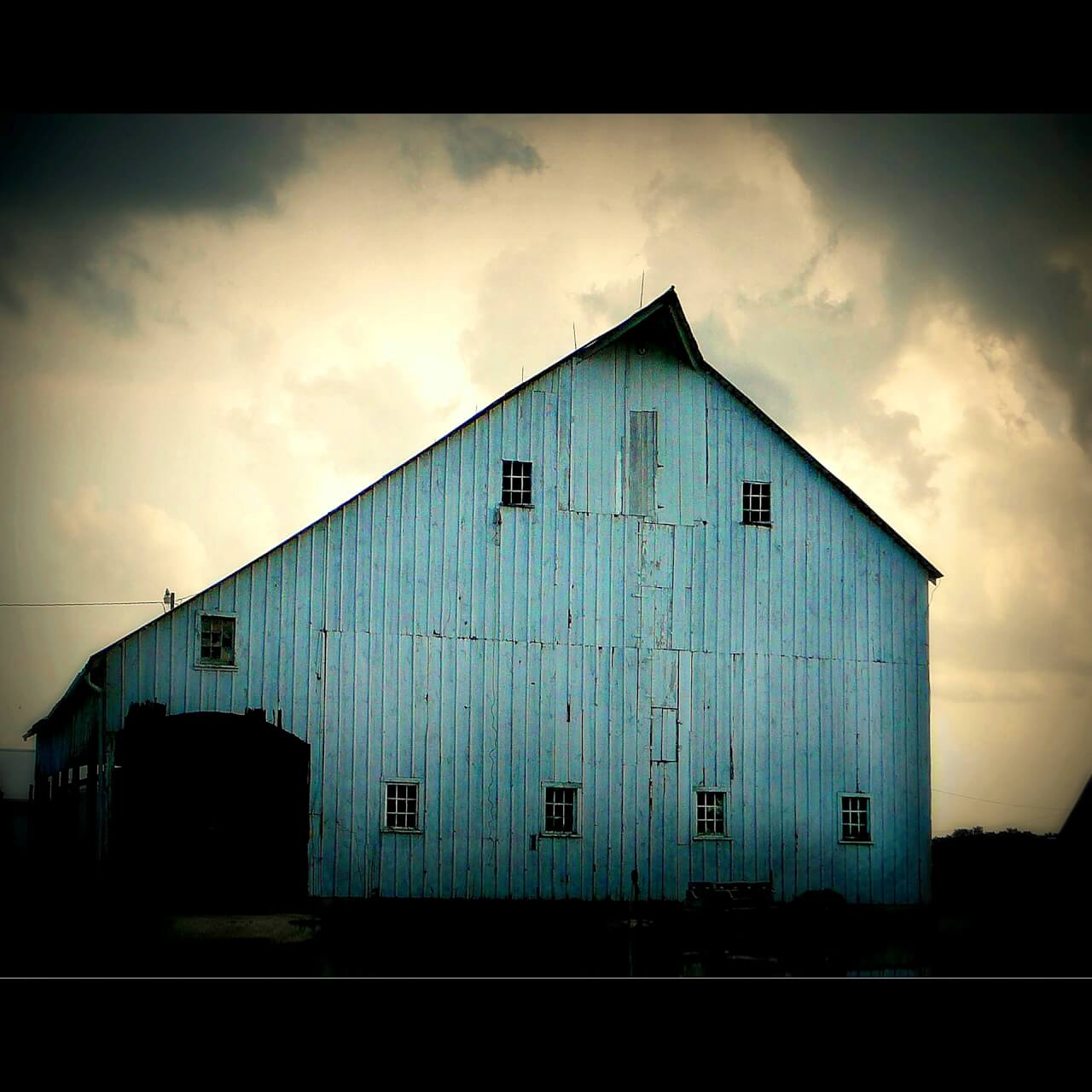 image of a barn with moody sky