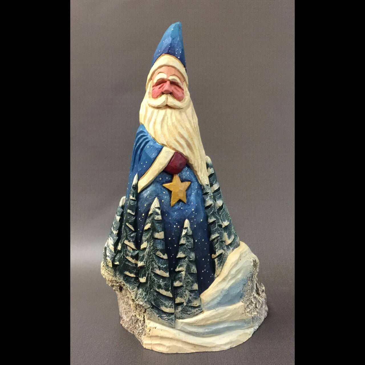 carved santa figure with blue hat and cloak