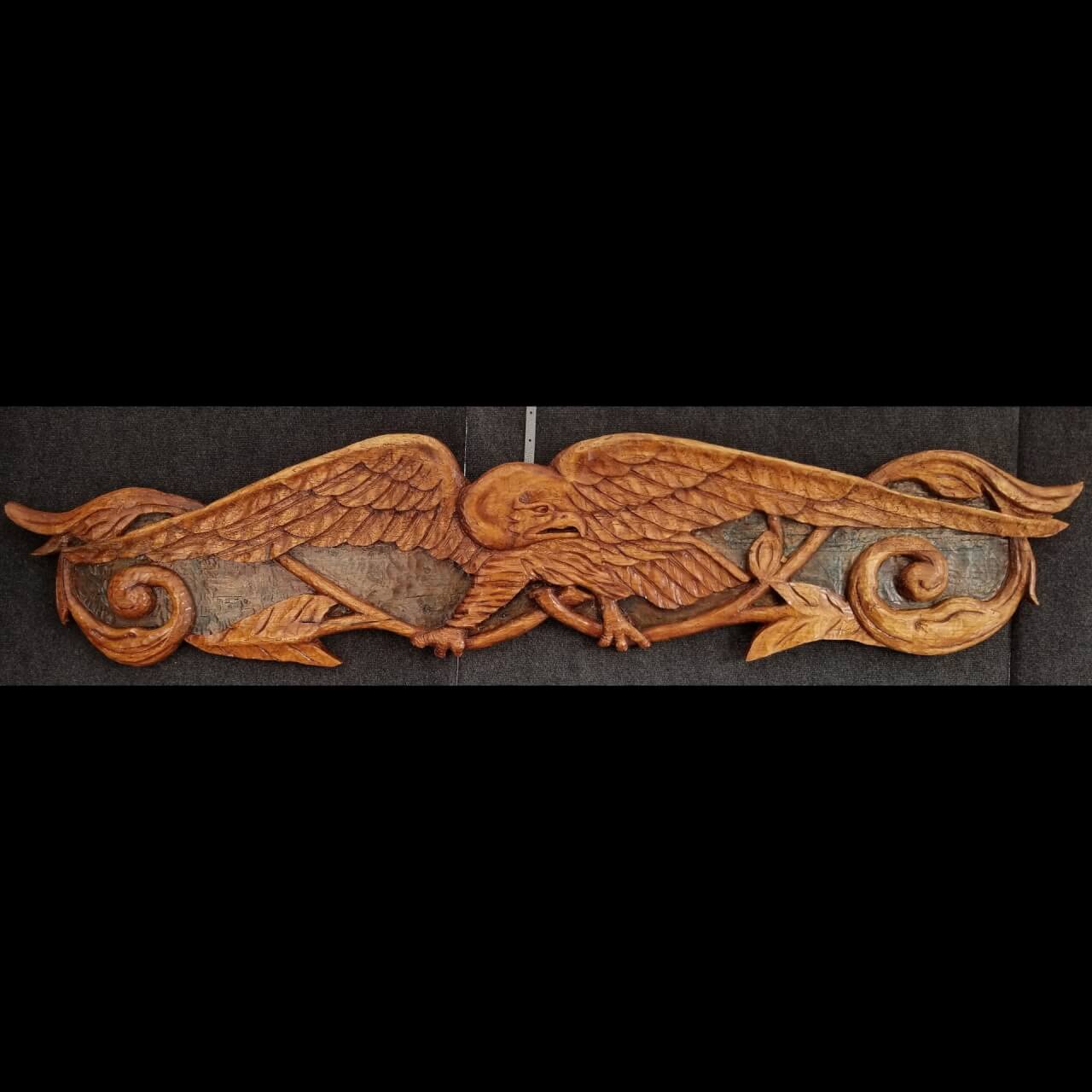 carved bird with scrolls