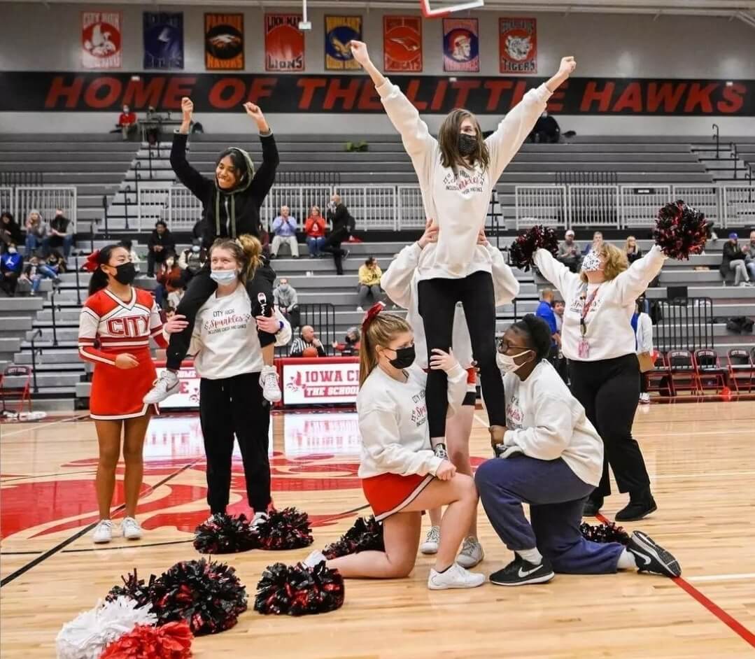 cheer-team-in-on-court-in-formation-with-individuals-lifted-up-and-arms-posed