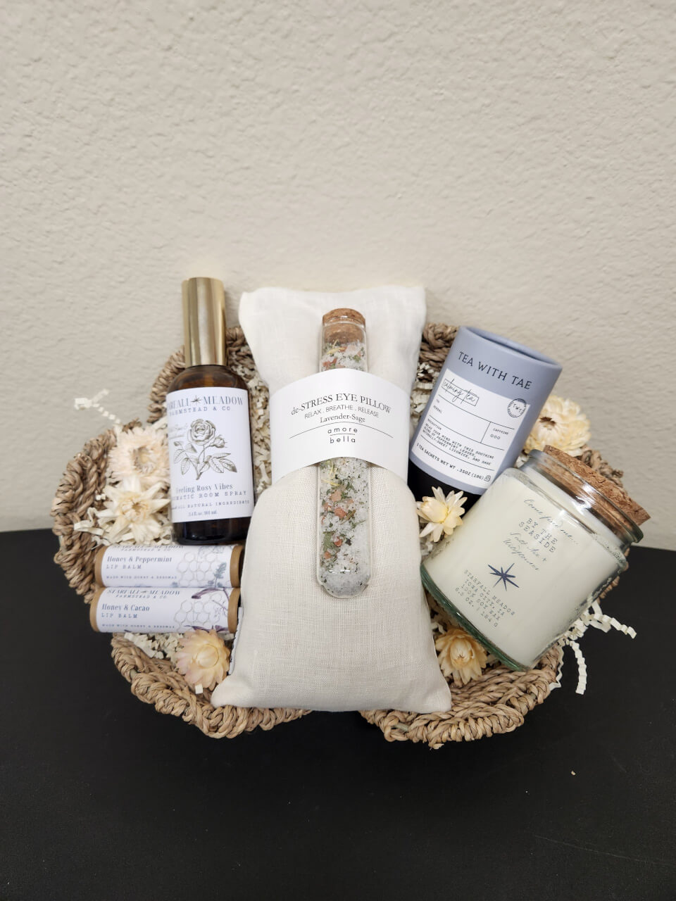 gift basket withmultiple items including eye pillow room spray bath salts lip balm and candles