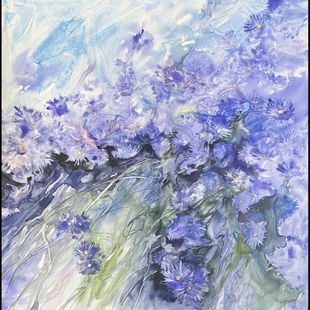 young painting blue flowers plant life